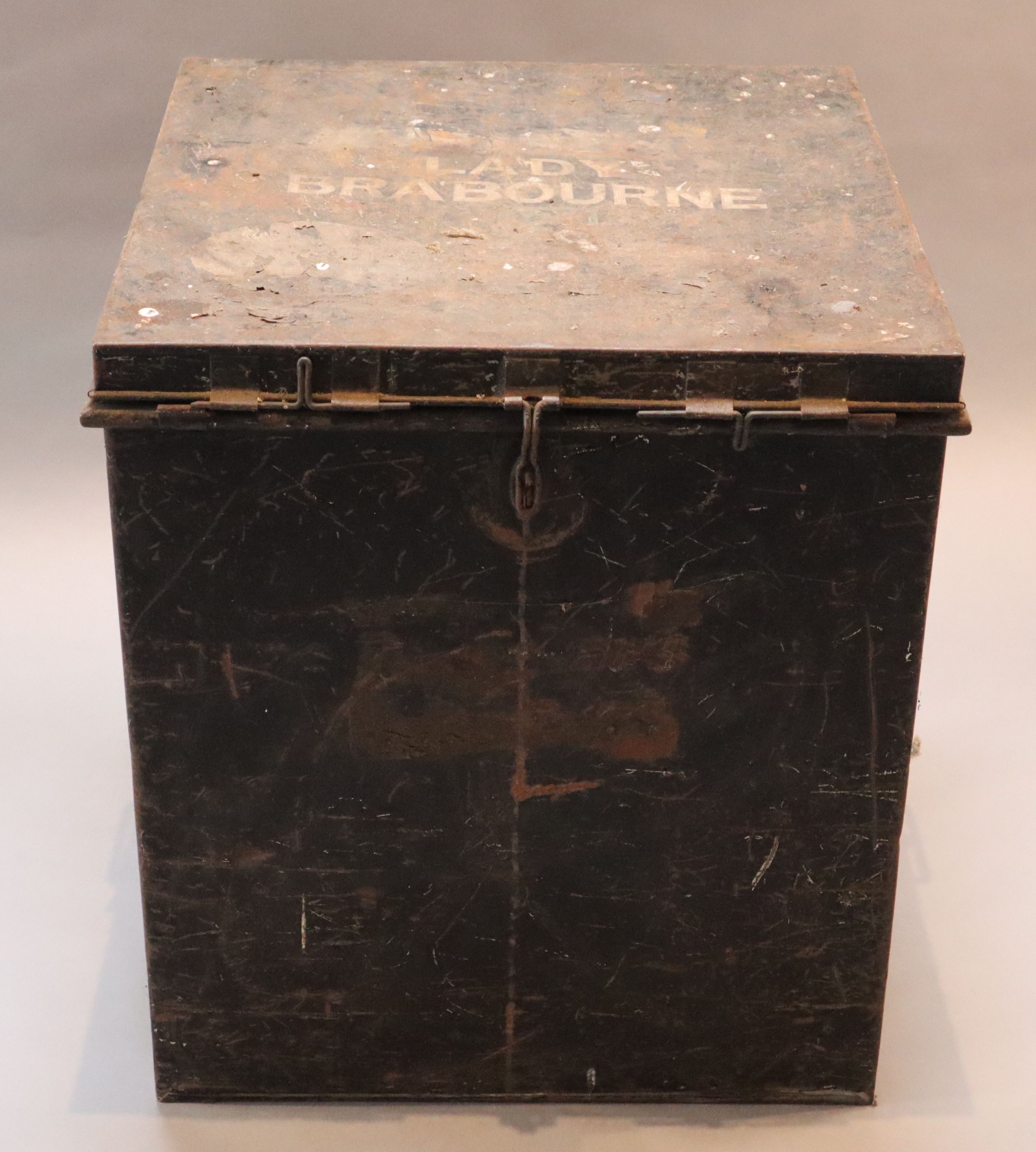 An early 20th century black painted tin travelling trunk, inscribed Lady Brabourne with old British India and Cooks Travel labels, wi